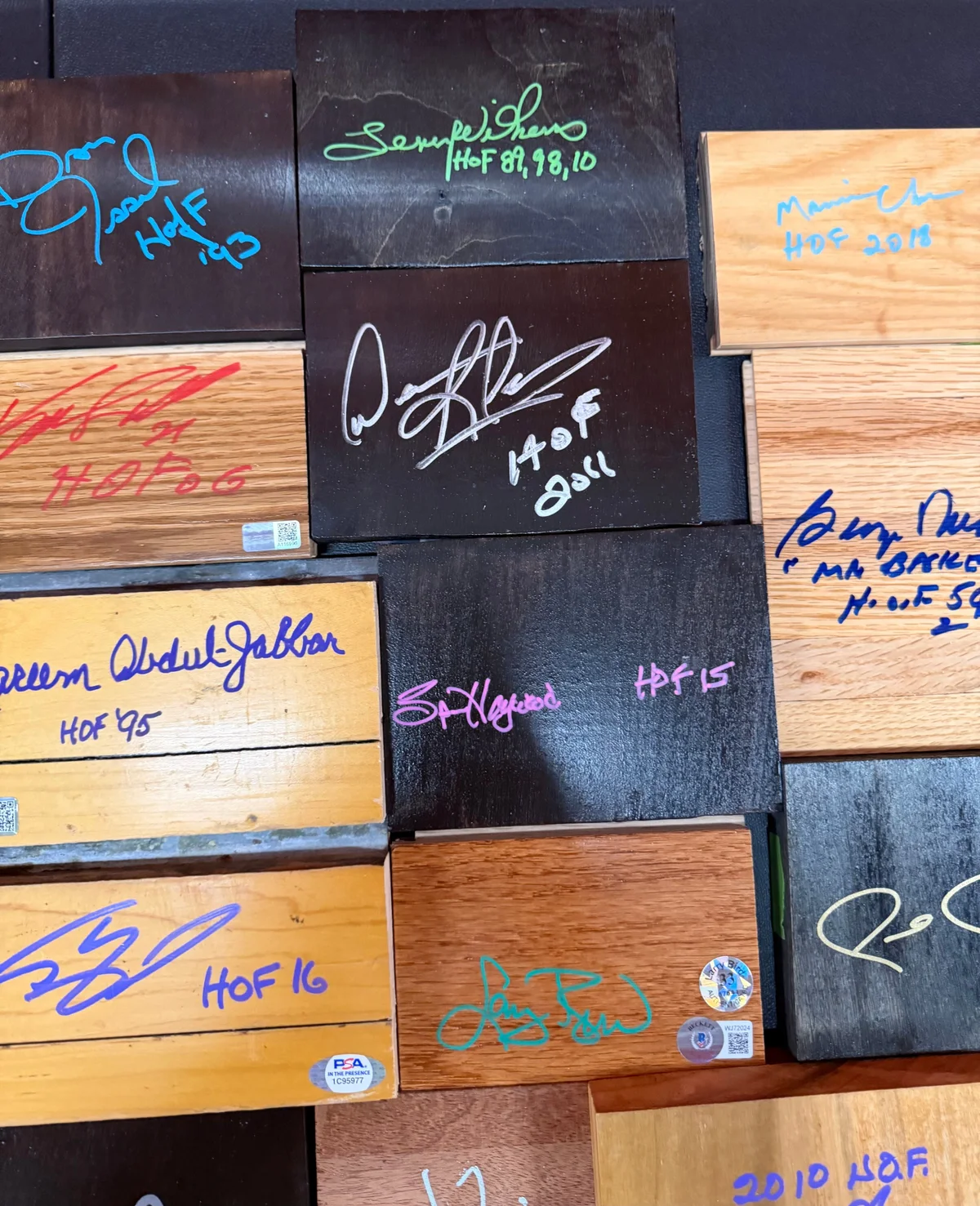 Game Used Floor and Wood Pieces Signed by NBA Hall of Famers - Collection Lot